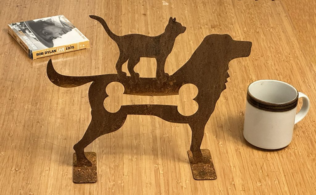 cat on a dog sculpture